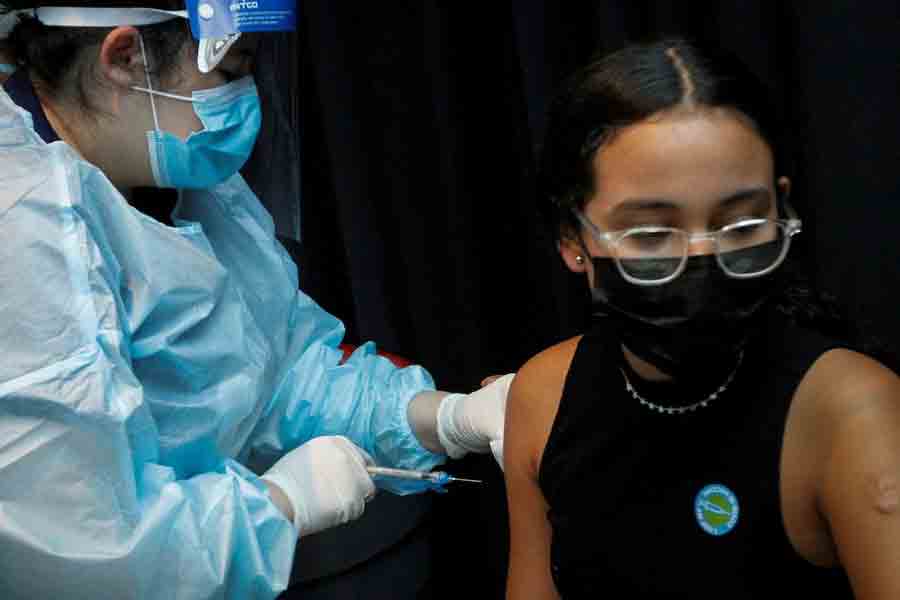 A girl is inoculated against the coronavirus disease (COVID-19) during a vaccination event hosted by Miami-Dade County and Miami Heat, at FTX Arena in Miami, Florida, US, August 5, 2021.