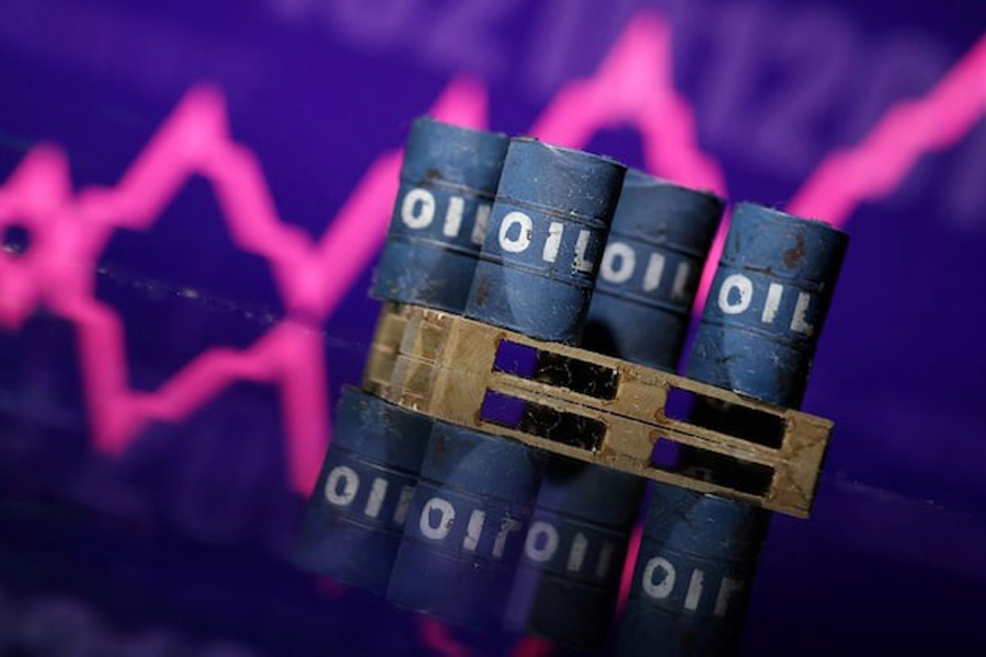 Miniatures of oil barrels and a rising stock graph are seen in this illustration taken January 15, 2024.
