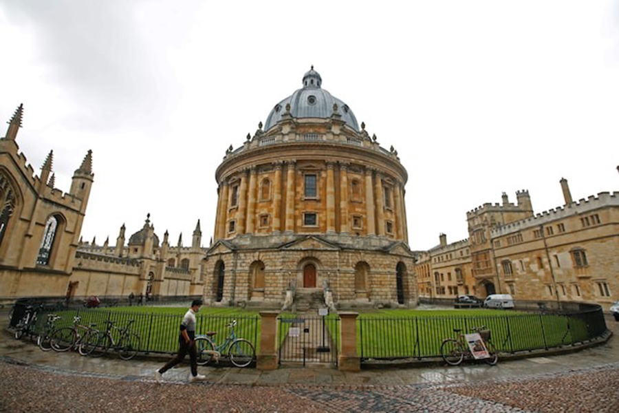 A man walks in front of the buildings of Oxford University, amid the spread of the coronavirus disease (Covid-19) in Oxford, Britain on October 6, 2020 — Reuters/File