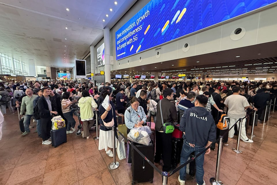 Travellers wait at Brussels airport, after a cyberattack at a service provider for check-in and boarding systems disrupted operations at several major European airports, in Zaventem near Brussels, Belgium September 20, 2025.