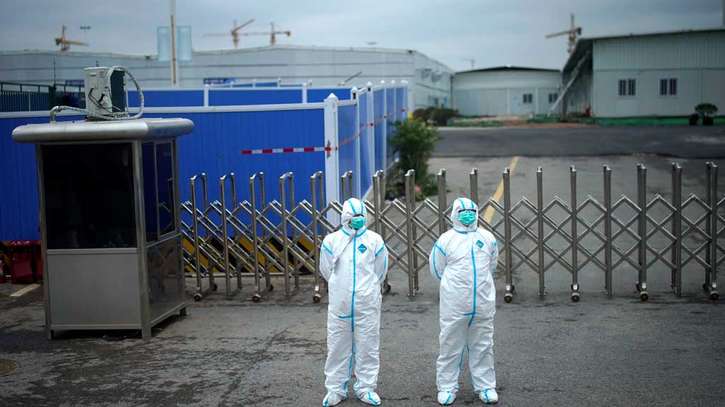 Workers in protective suits are seen at the Leishenshan Hospital, a makeshift hospital for treating patients with the coronavirus disease (COVID-19), in Wuhan, Hubei province, China Apr 11, 2020. REUTERS/Aly Song/File Photo