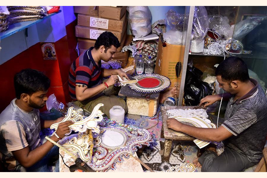 Artisans make decorations for the Durga Puja festival in Dhaka —Agency Photo