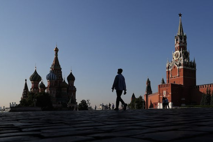 People walk in front of St. Basil's Cathedral and Spasskaya Tower in Red Square in Moscow, Russia July 25, 2025.