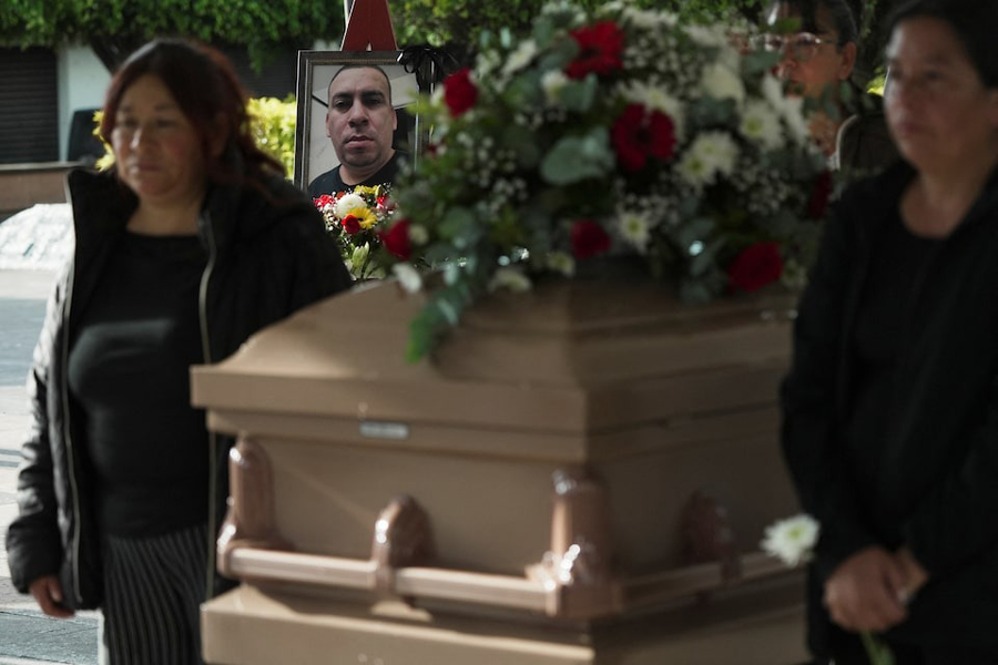 A framed photo of Silverio Villegas Gonzalez, 38, a man from Michoacan who was fatally shot by a U.S. Immigration and Customs Enforcement (ICE) agent in Franklin Park, Illinois, shortly after dropping off his two children at a nearby elementary school and daycare, is placed next to his casket during a tribute by local authorities in Irimbo, Mexico, September 26, 2025.