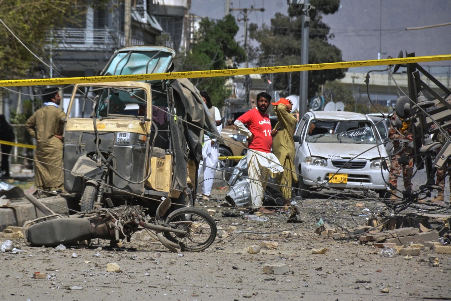 Rescue workers and security officials examine damaged vehicles at the site of a powerful car bombing, in Quetta, Pakistan, Tuesday, Sept. 30, 2025. (AP Photo/Arshad Butt)