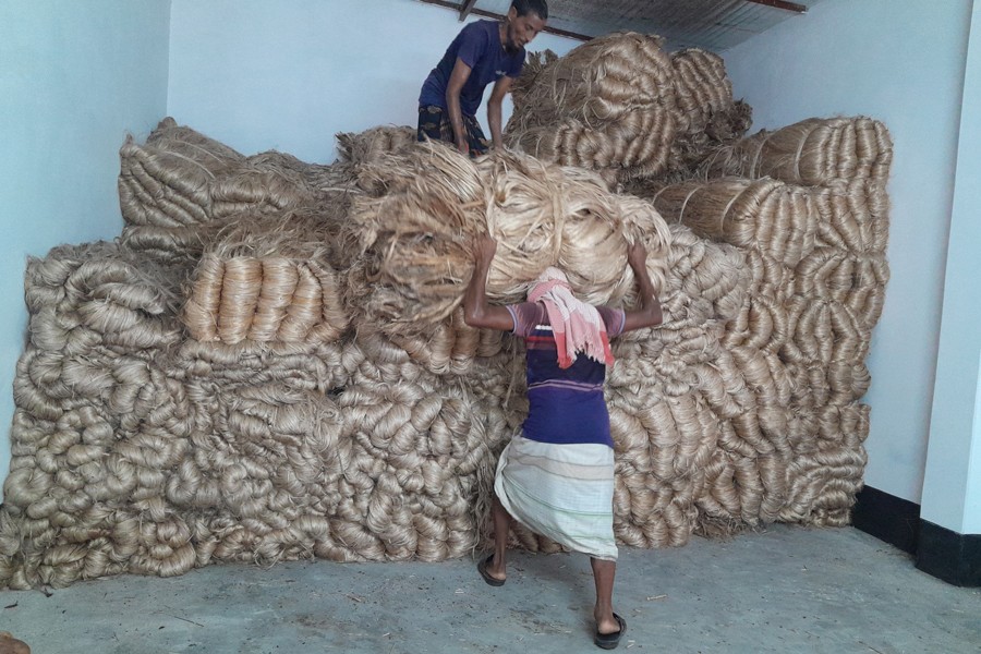 Photo shows workers busy arranging jute in a godown at Nohata Bazar in Paba upazila of Rajshahi district - FE Photo