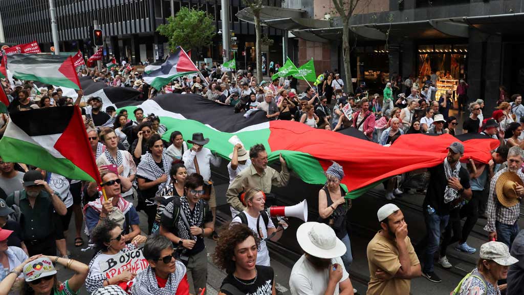 Demonstrators hold a large Palestinian flag during the 'Nationwide March for Palestine', after a ceasefire between Israel and Hamas in Gaza went into effect, in Sydney, Australia, Oct 12, 2025. REUTERS