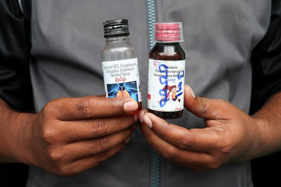 Saddam Mansuri, the father of two, shows bottles of Coldrif, linked to the deaths of several children and a Relife cough syrup, which is not linked to any deaths, but Indian authorities have asked people to avoid it, which he had been giving his one-year-old child, in Parasia, Madhya Pradesh, India on October 10, 2025 — Reuters/File