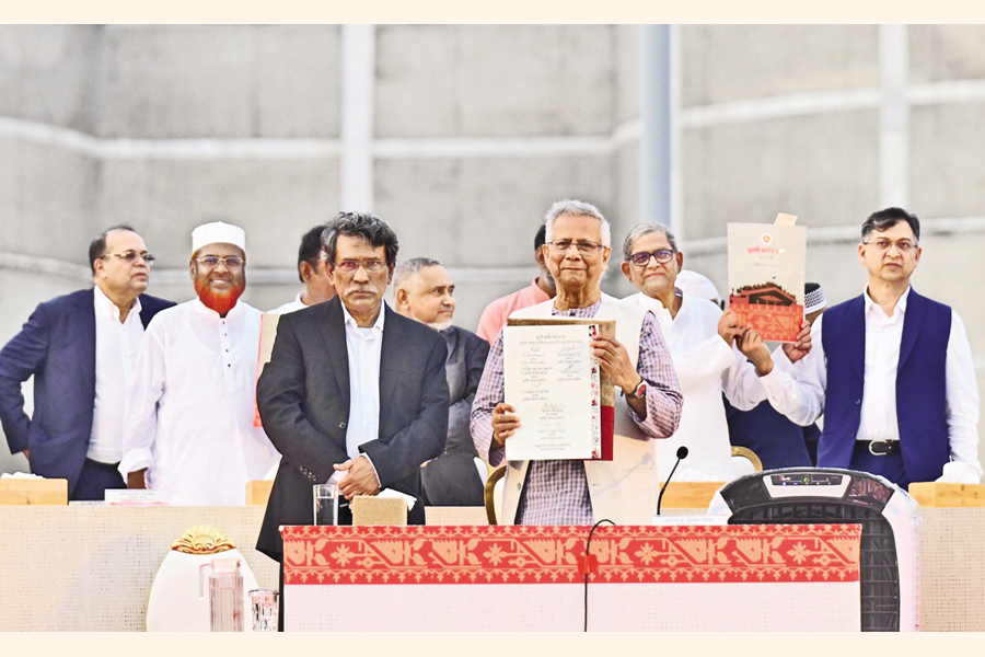 Chief Adviser Mohammad Yunus holds up the July Charter, flanked by leaders of different political parties, including BNP Secretary-General Mirza Fakhrul Islam Alamgir, after the signing of the Charter at a grand event on the Parliament premises in the city on Friday. — Collected
