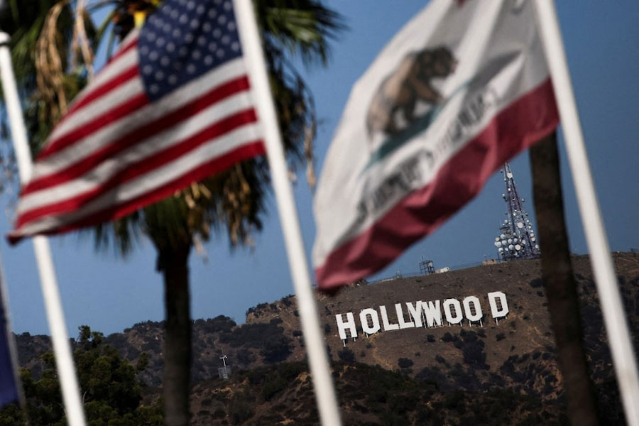 Flags flutter in front of the Hollywood sign after US President Donald Trump ordered a 100 per cent tariff on foreign-made films in Los Angeles, California, US, September 29, 2025.