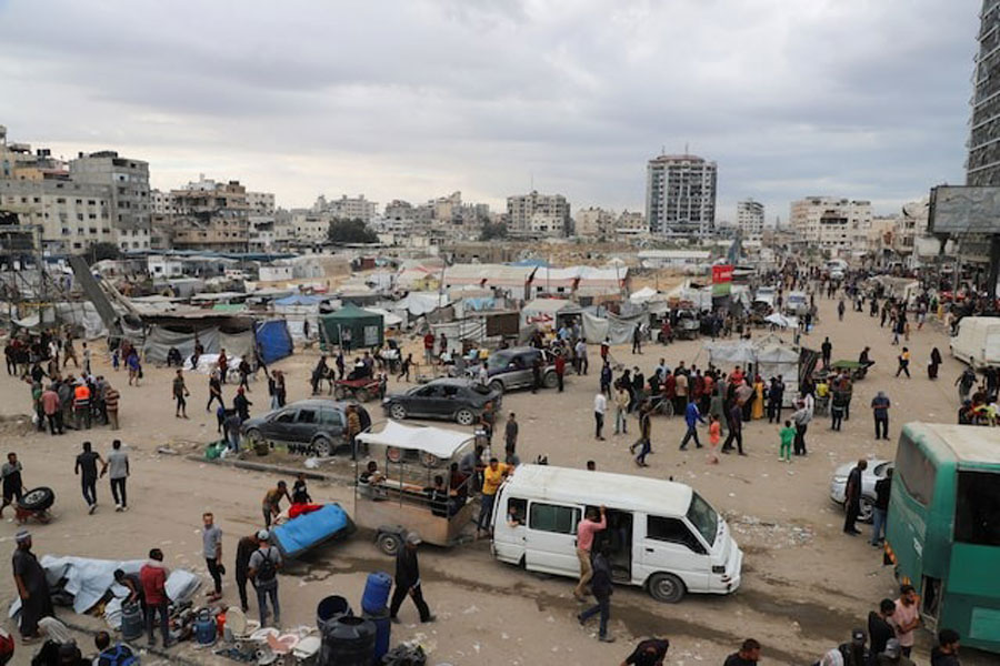 Palestinians gather at a street market during a ceasefire between Israel and Hamas, in Gaza City, October 12, 2025.