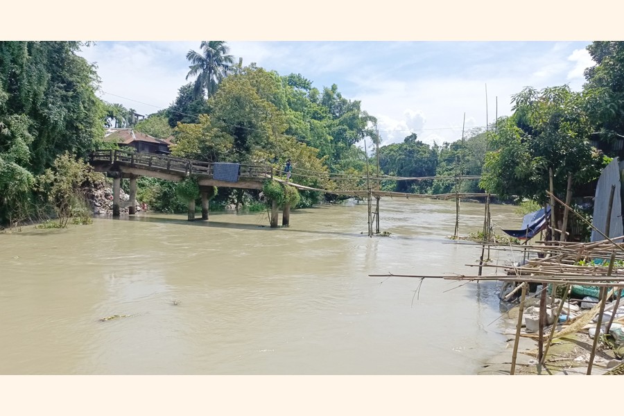 Photo shows a child crossing the dilapidated bridge over the Ichamati River at Kusta Purbo Para in Ghior upazila of Manikganj district- FE Photo