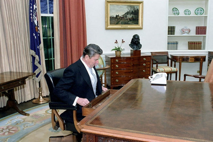 Ronald Reagan sits at the Oval Office desk following his inaugural parade in Washington, D.C., U.S. in January 1981.
