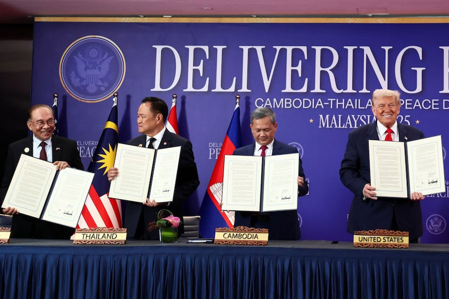 Malaysia's Prime Minister Anwar Ibrahim, Thailand's Prime Minister Anutin Charnvirakul, Cambodia's Prime Minister Hun Manet and U.S. President Donald Trump hold up documents during the signing of a ceasefire deal between Cambodia and Thailand on the sidelines of the 47th Association of Southeast Asian Nations (ASEAN) summit in Kuala Lumpur, Malaysia, October 26, 2025.