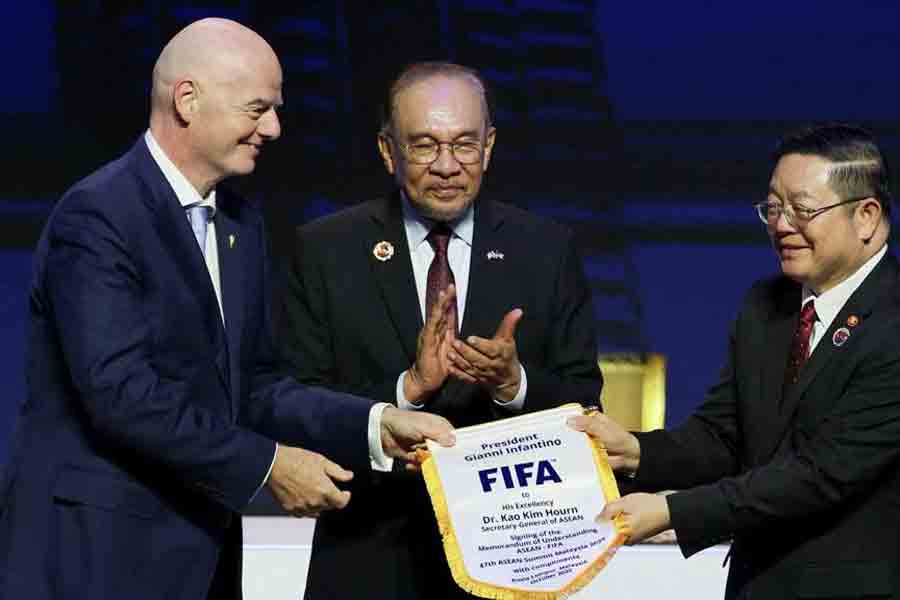 ASEAN Secretary-General Kao Kim Hourn, Malaysian Prime Minister Anwar Ibrahim and FIFA Chief Gianni Infantino attend a signing ceremony for the ASEAN-FIFA memorandum of understanding in football development on the sidelines of the 47th ASEAN Summit in Kuala Lumpur, Malaysia Oct 26, 2025.