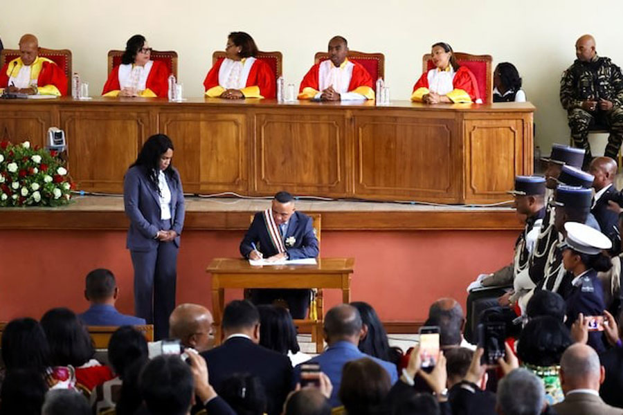 Madagascar's new military ruler, Colonel Michael Randrianirina, signs documents after being sworn in as president on Friday, taking over from Andry Rajoelina following a coup that ousted him, at the constitutional court in Antananarivo, Madagascar, October 17, 2025.