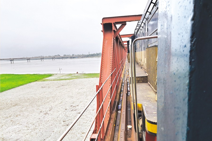 The train trundles on the Teesta bridge, the gateway to Lalmonirhat and Kurigram from Rangpur. — FE Photo