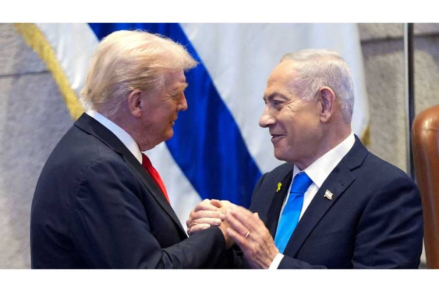President Donald Trump talks with Israel’s Prime Minister Benjamin Netanyahu at the Knesset, Monday, Oct 13, 2025, in Jerusalem.