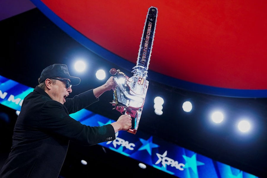 Elon Musk holds up a chainsaw onstage during the Conservative Political Action Conference (CPAC) in National Harbor, Maryland, US, February 20, 2025.
