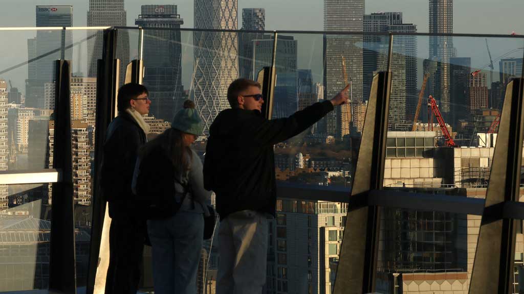 People look out from a rooftop garden in the City of London business district with skyscrapers of Canary Wharf commercial district seen behind, as Britain’s Chancellor Rachel Reeves faces tough financial decisions ahead of her second budget statement next week, in London, Britain, Nov 21, 2025. REUTERS