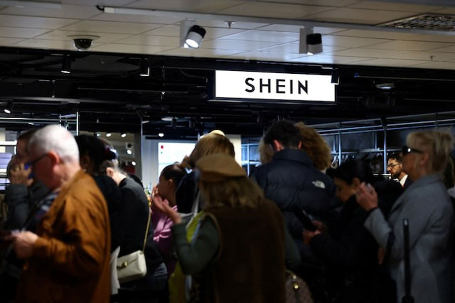 Customers queue to enter the first physical space of Chinese online fast-fashion retailer Shein on the day of its opening inside the Le BHV Marais department store, the Bazar de l'Hotel de Ville, in Paris, France, November 5, 2025.