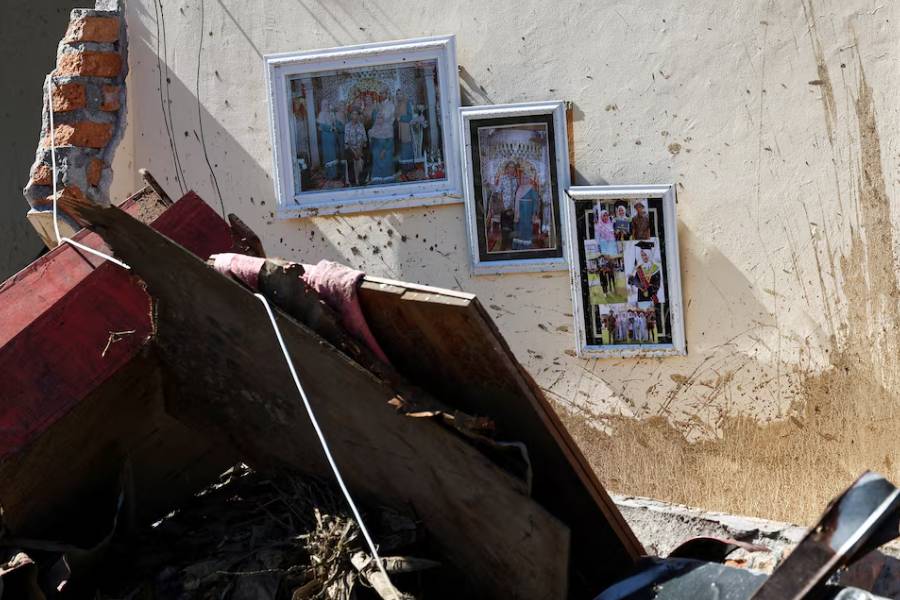 Photographs hang on the wall of a heavily damaged house in an area hit by deadly flash floods following heavy rains in Palembayan, Agam regency, West Sumatra province, Indonesia, December 1, 2025.