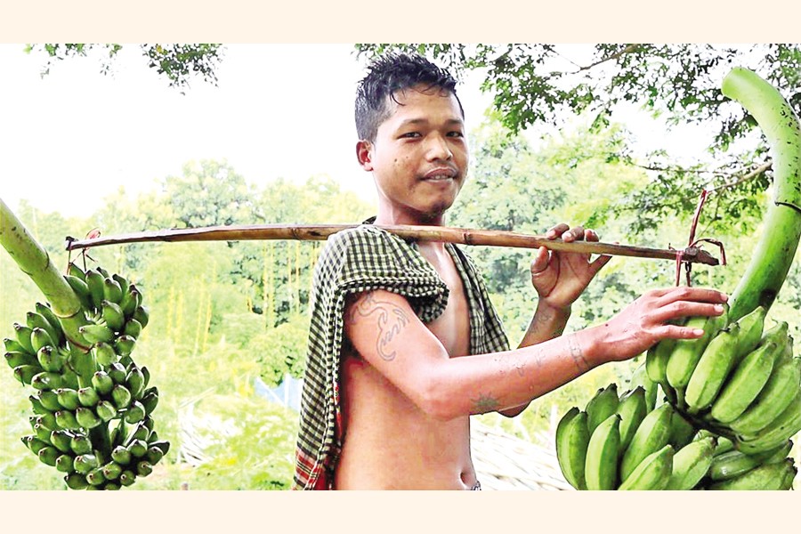A farmer carrying his harvest. — FE Photo