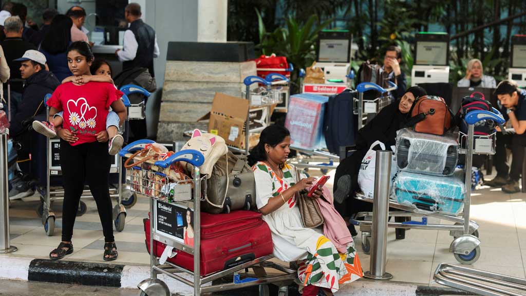 Passengers wait outside the IndiGo airlines ticketing counter at the Chhatrapati Shivaji Maharaj International Airport, after several IndiGo airlines flights were cancelled, in Mumbai, India, Dec 6, 2025. REUTERS