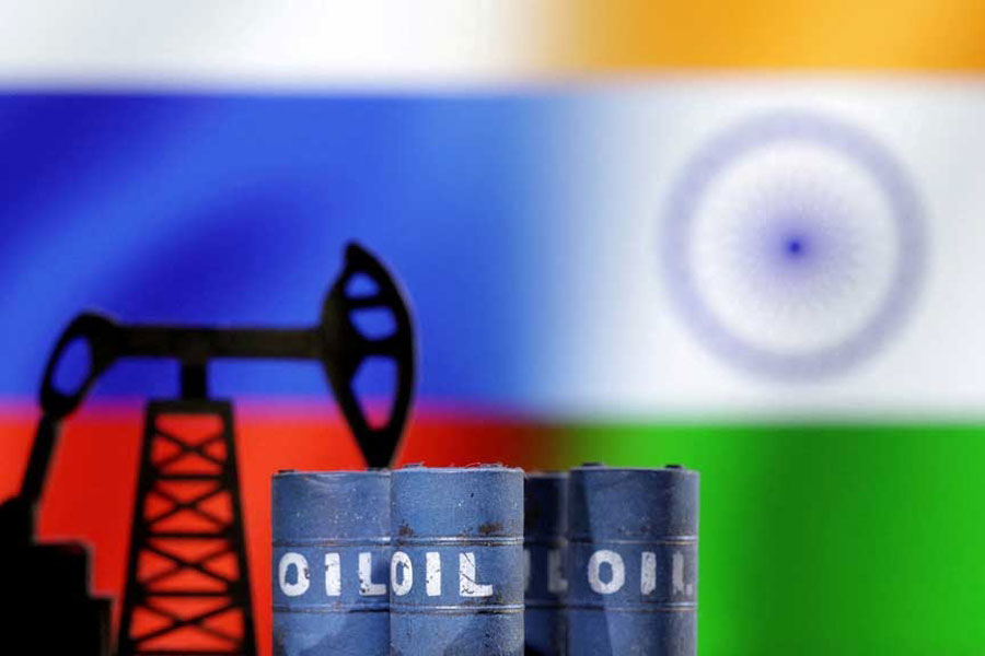 A model of an oil pump and oil barrels jack is seen in front of Russian and Indian flags in this illustration taken, Dec 9, 2022.