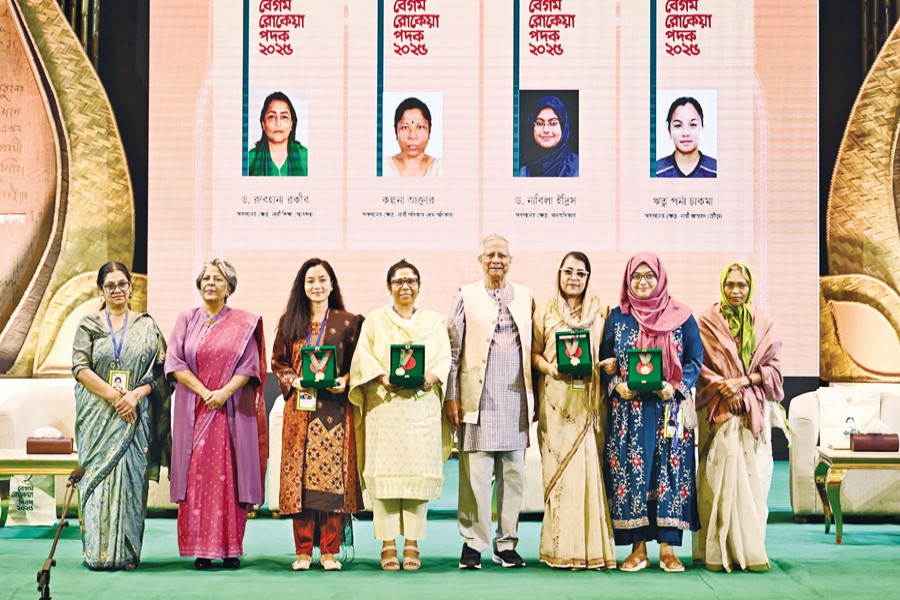 Recipients of Begum Rokeya Padak 2025, along with others, pose with Chief Adviser Professor Muhammad Yunus at a programme at the Osmani Memorial Auditorium in Dhaka on Tuesday. — PID