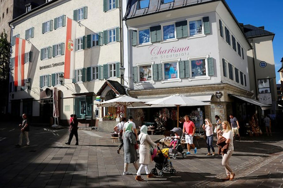 Shoppers walk past a souvenir shop in Zell am See, Austria, August 31, 2016.