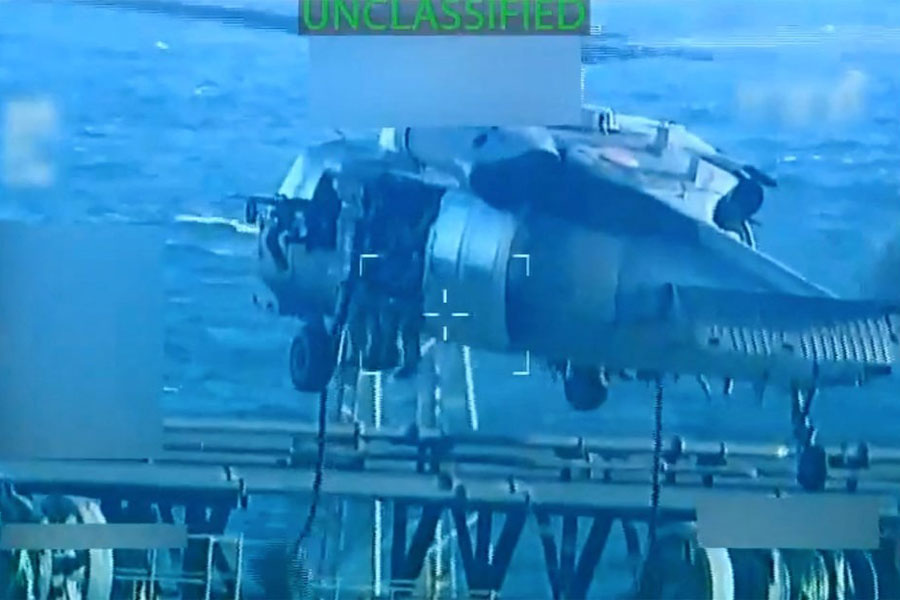 US forces abseil onto an oil tanker during a raid described by US Attorney General Pam Bondi as its seizure by the United States off the coast of Venezuela, December 10, 2025, in a still image from video.