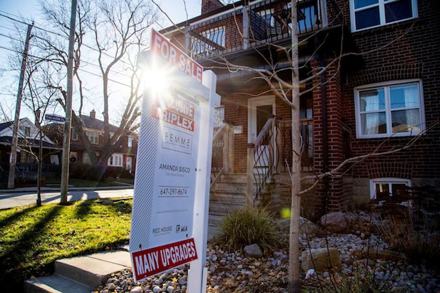 A for sale sign is displayed outside a home in Toronto, Ontario in Toronto, Ontario, Canada December 13, 2021.