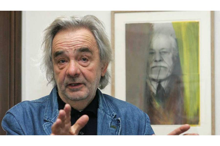 Austrian artist Arnulf Rainer gestures as he poses for photographers in front of an overpainted portrait of psychoanalyst Siegmund Freud at Siegmund Freud Museum in Vienna Nov 22, 2006.