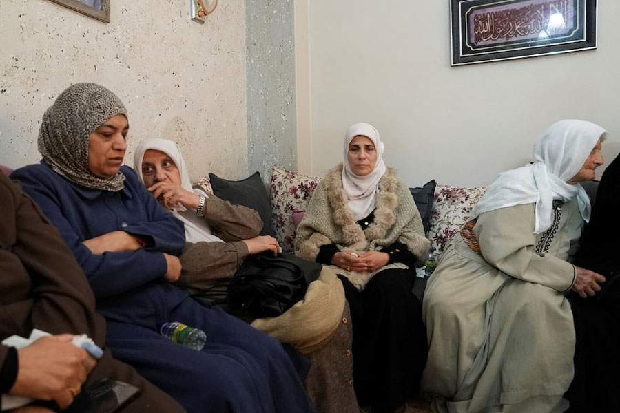 Ibtihal Mualla, the mother of 16-year old Palestinian Rayyan Abu Mualla who was killed by Israeli forces during a raid, looks on as women gather at her home in Qabatiya in the Israeli-occupied West Bank, December 21,2025.