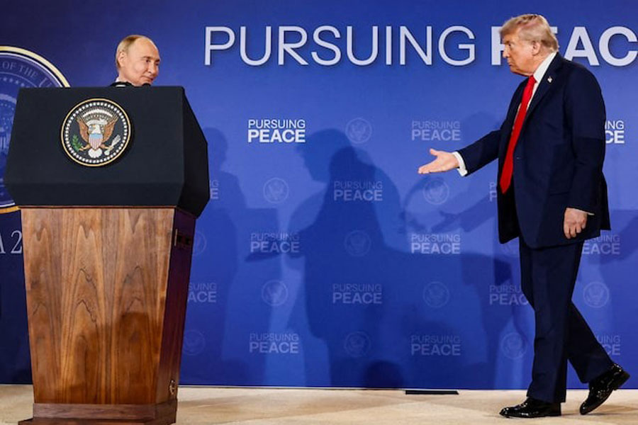 US President Donald Trump walks towards Russian President Vladimir Putin during a press conference following their meeting to negotiate an end to the war in Ukraine, at Joint Base Elmendorf-Richardson, in Anchorage, Alaska, US, August 15, 2025.