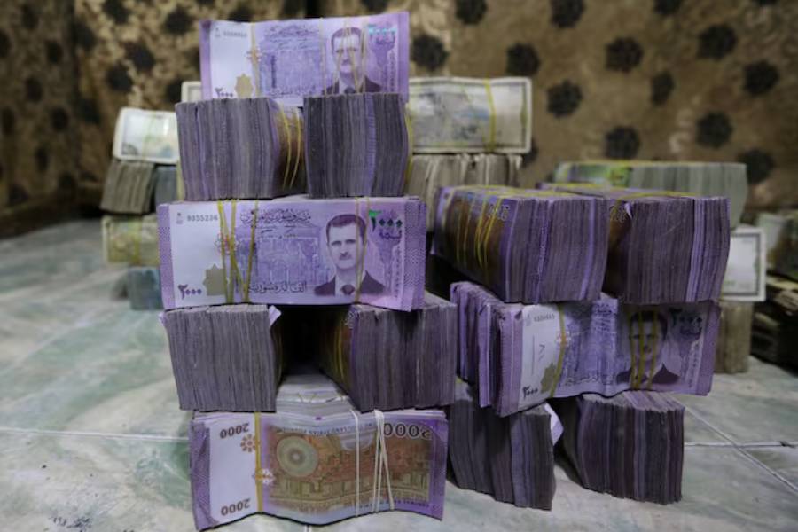 Stacks of Syrian pounds are pictured inside an exchange currency shop in Azaz, Syria February 3, 2020.