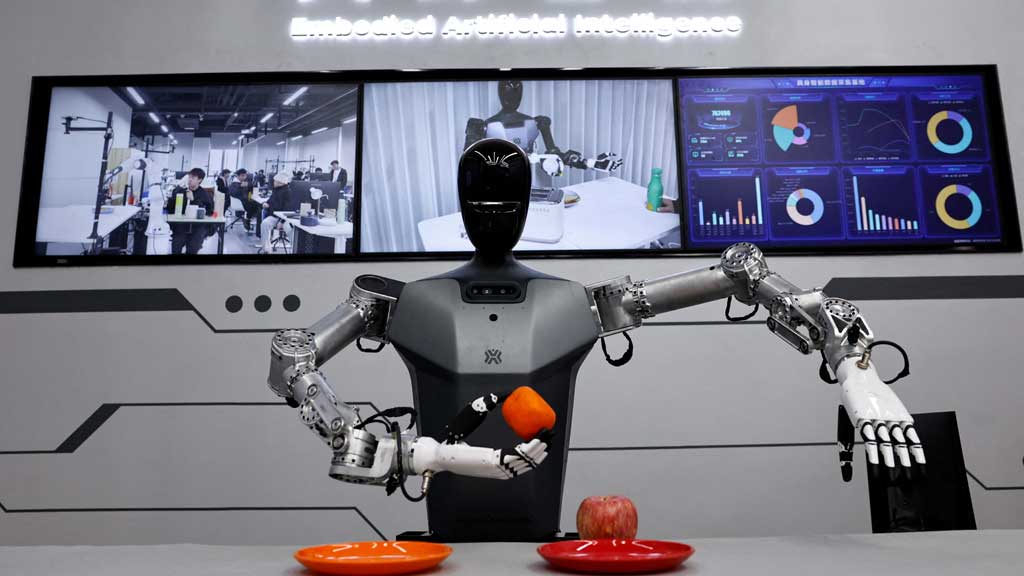 FILE PHOTO: A humanoid robot Tiangong by Beijing Innovation Center of Humanoid Robotics Co, moves an orange as a demonstration at its company, during an organised media tour to Beijing Robotics Industrial Park, in Beijing Economic-Technological Development Area, also known as Beijing E-Town, China May 16, 2025. REUTERS