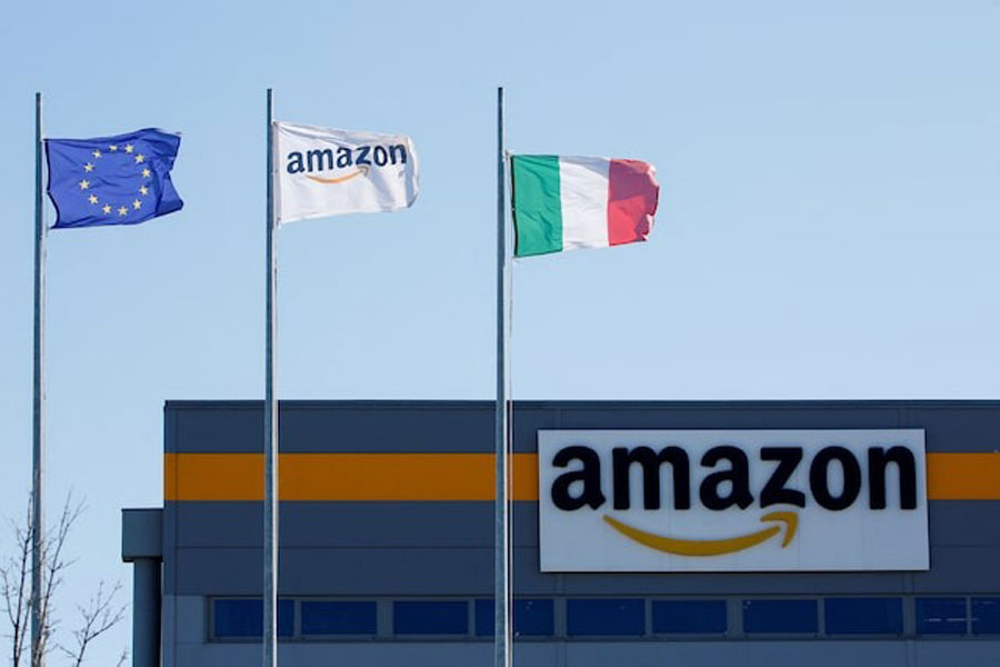 Flags flutter outside a distribution centre at Amazon's logistics operations in Italy, in Passo Corese, Italy March 22, 2021.