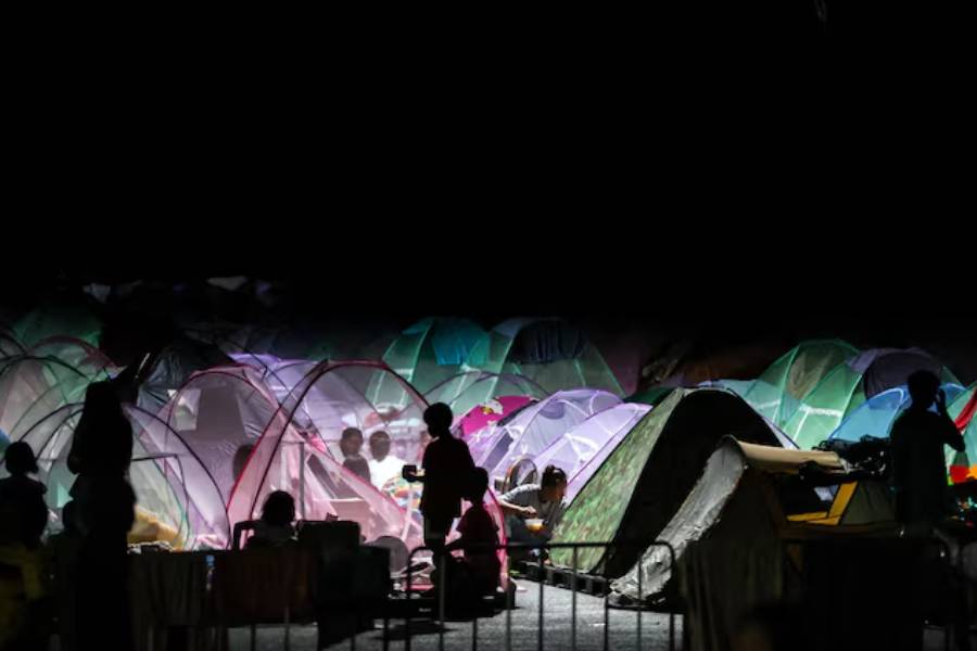 Displaced people gather inside a temporary shelter amid clashes between Thailand and Cambodia along a disputed border area, in Buriram province, Thailand, December 16, 2025.