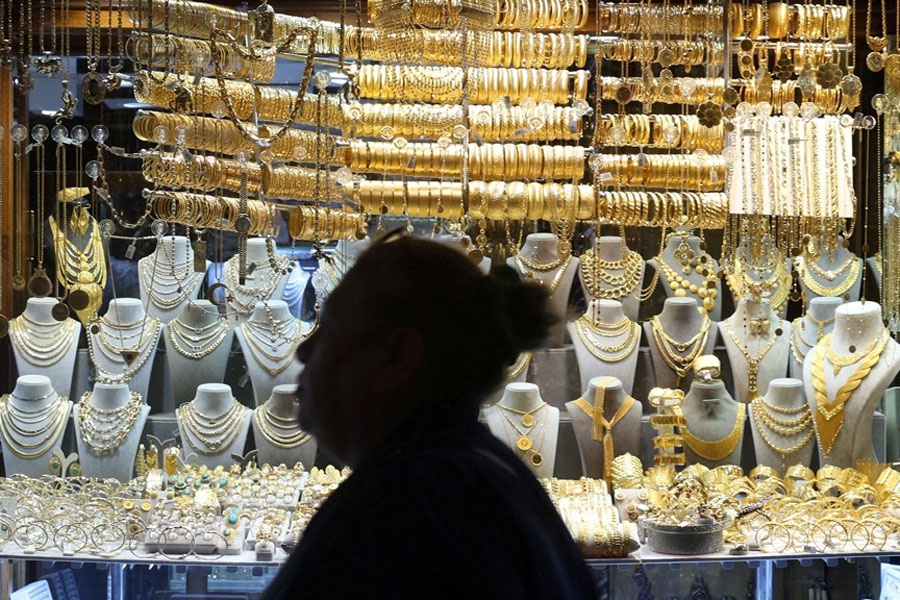 A woman walks past a jewellery shop at the Grand Bazaar in Istanbul, Turkey, Oct 17, 2025.