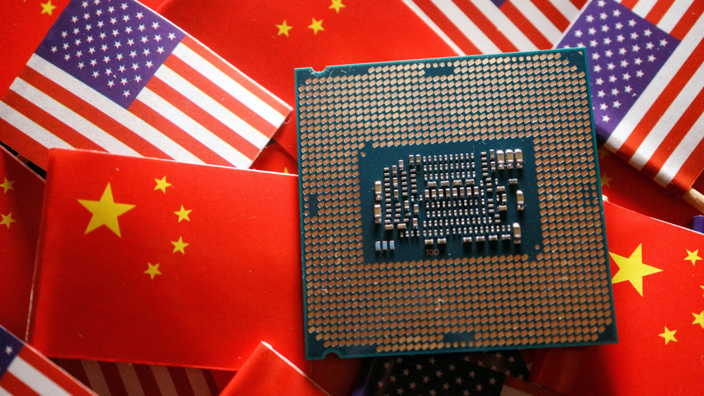 A central processing unit semiconductor chip is displayed among flags of China and the US, in this illustration picture taken Feb 17, 2023. REUTERS/Florence Lo/Illustration/File Photo