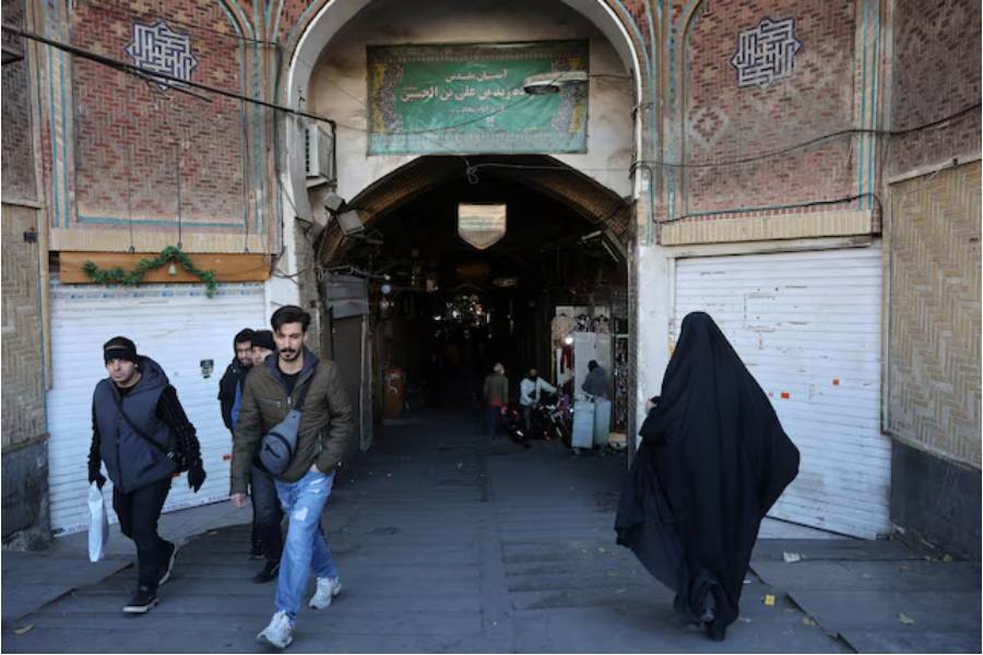People walk past closed shops following protests over a plunge in the currency’s value, in the Tehran Grand Bazaar in Tehran, Iran, December 30, 2025.