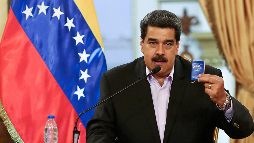 Venezuela's President Nicolas Maduro holds a copy of the Venezuelan constitution while he speaks during a meeting with members of the Venezuelan diplomatic corp after their arrival from the United States, at the Miraflores Palace in Caracas, Venezuela Jan 28, 2019. Miraflores Palace/Handout via REUTERS