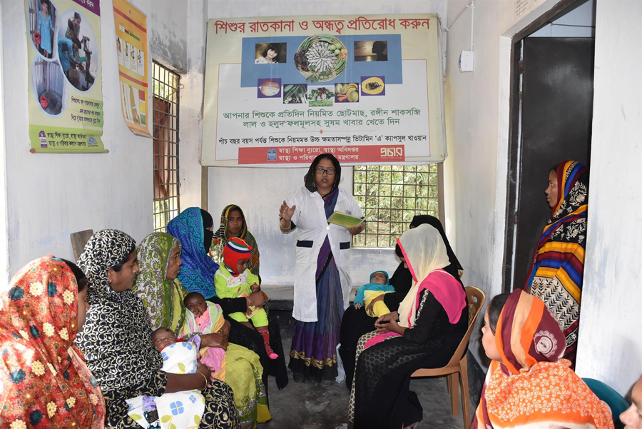 A heath worker providing health tips to a group of young mothers at a community clinic in Bangladesh — WHO Photo