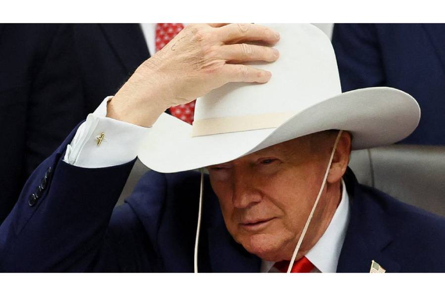 US President Donald Trump wears a hat Captain Mike Eruzione gave him on the day he signs a bill to award congressional gold medals to members of the 1980 US Olympic men’s hockey team, who went on to win gold after defeating a heavily-favored Soviet Union team in their “Miracle on Ice” medal-round match, in the Oval Office at the White House in Washington, DC, US. Dec 12, 2025.