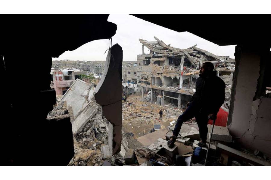 Palestinians inspect the site of Thursday’s Israeli strike on a house, in the central Gaza Strip, Jan 9, 2026.