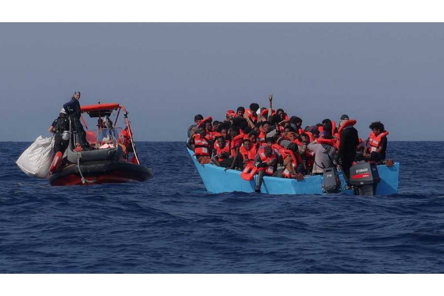 Migrants aboard an overcrowded boat react as they are approached by German NGO Sea-Watch rescuers in the Mediterranean off Libya, Aug 11, 2025.