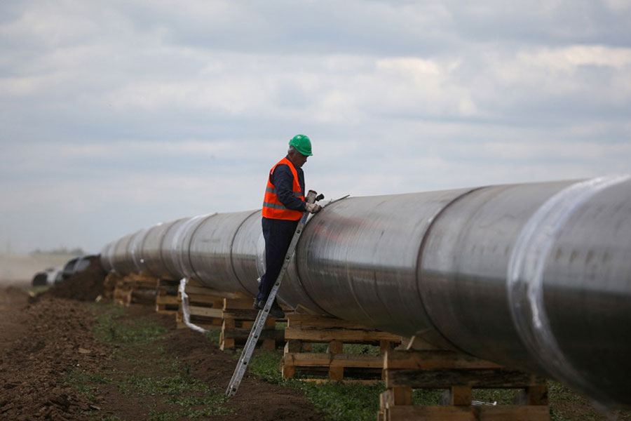 A worker is seen next to a pipe at a construction site on the extension of Russia's TurkStream gas pipeline after a visit of Serbia's President Aleksandar Vucic and Bulgaria's Prime Minister Boyko Borissov, in Letnitsa, Bulgaria, Jun 1, 2020.