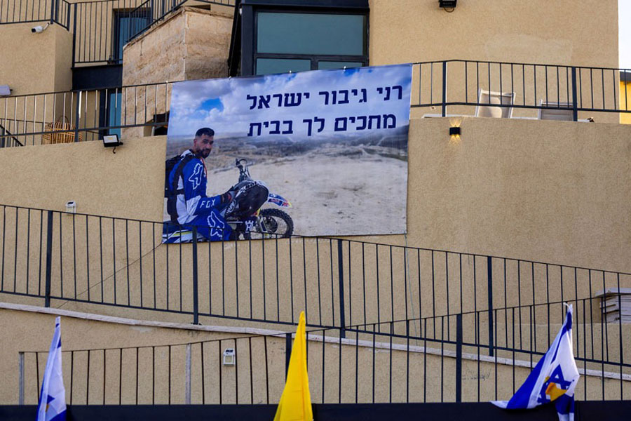 A sign depicting Ran Gvili, the last hostage remaining in Gaza following the deadly Oct 7, 2023 attack by Hamas, says in Hebrew "Rani, hero of Israel, we're waiting for you at home", on the outside of the family home in Meitar, Israel Dec 7, 2025. According to his mother, Ran Gvili, who served in an elite Israeli police unit, was injured fighting during the attack and later confirmed dead.